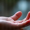 Subtle illustration of biofeedback sensors on fingertips, connected to a calming visual display, representing stress management.